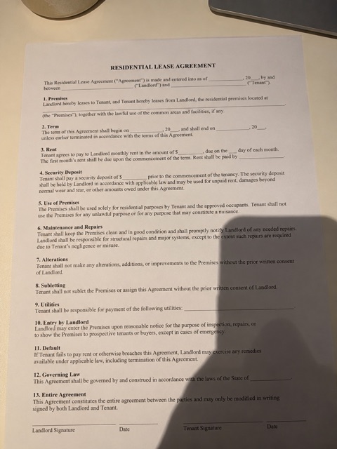 A printed page photographed from above with a phone and hand shadow on it